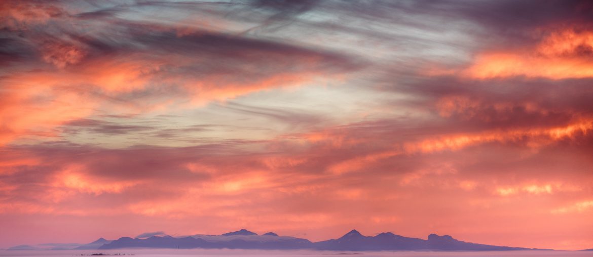 Sunset over Faxabugten with distant mountains
