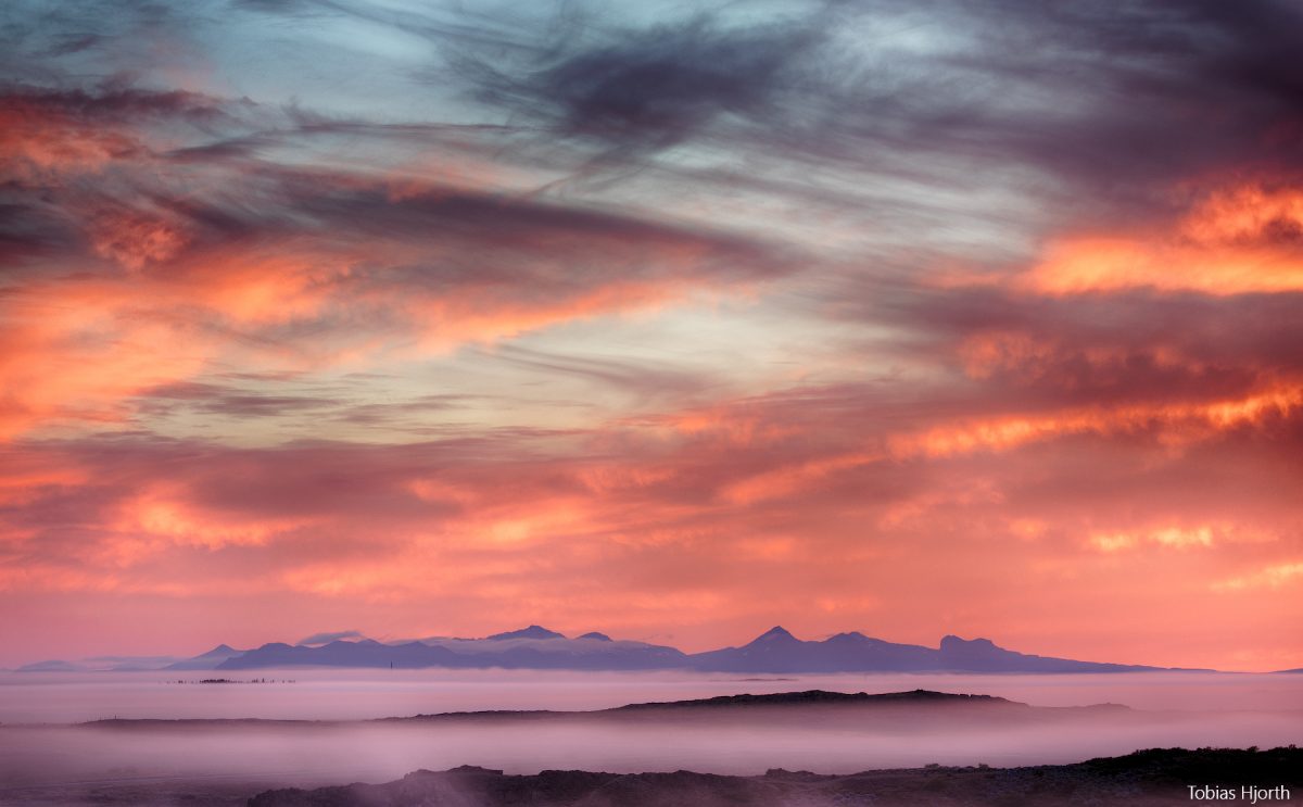 Sunset over Faxabugten with distant mountains